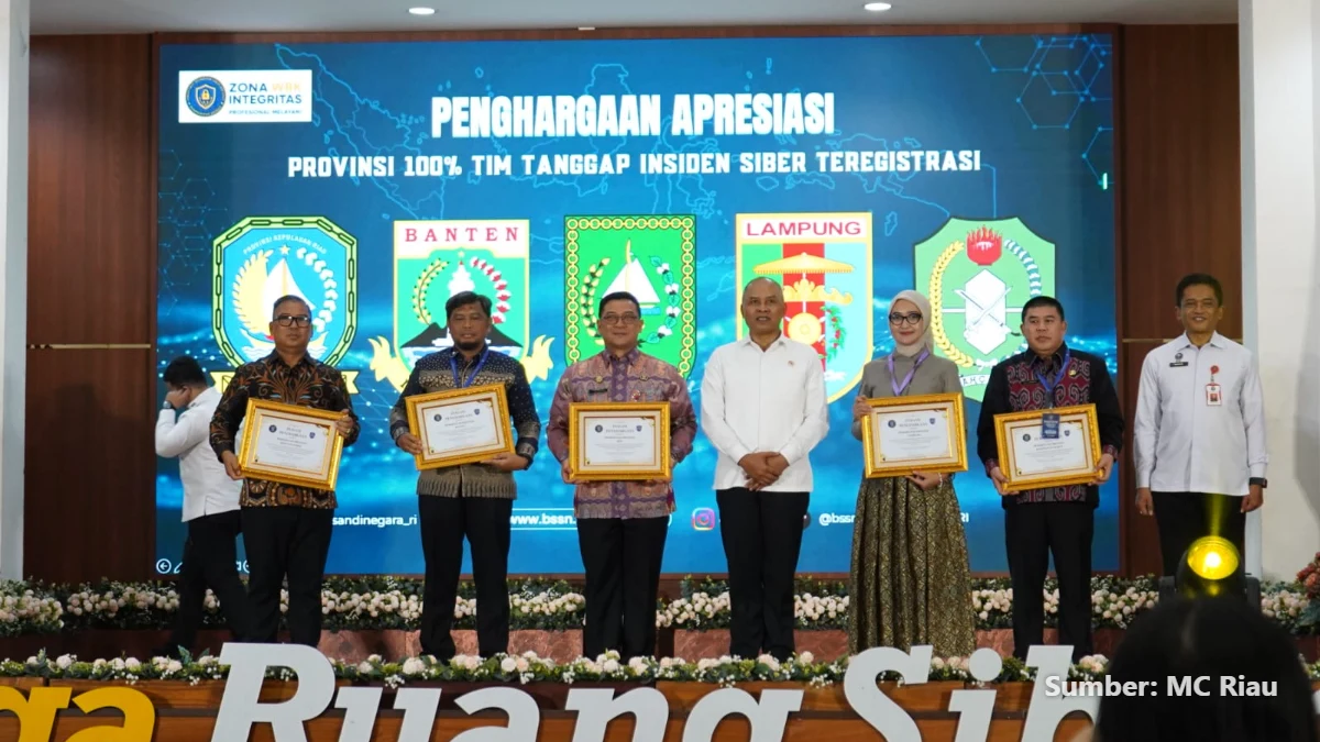 Kepala BSSN Nugroho Sulistyo Budi menyerahkan penghargaan kepada Sekretaris Daerah Riau